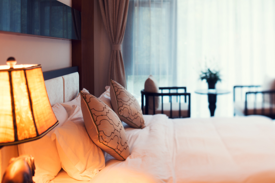 hotel room with queen bed and lamp